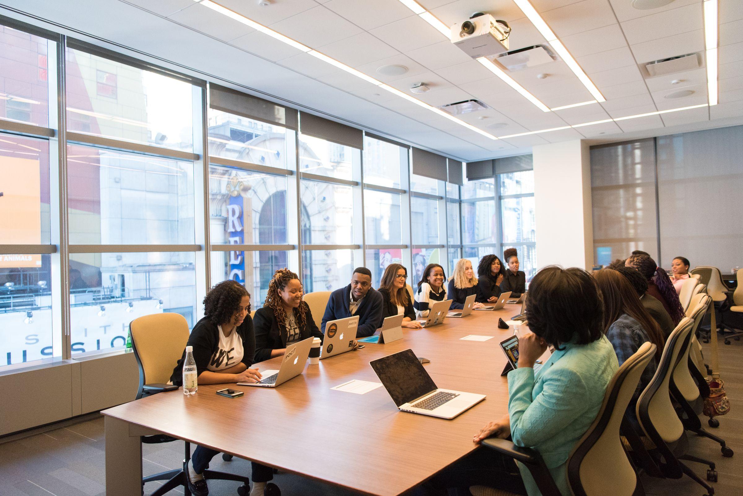 A team collaborating around a boardroom table in a modern office