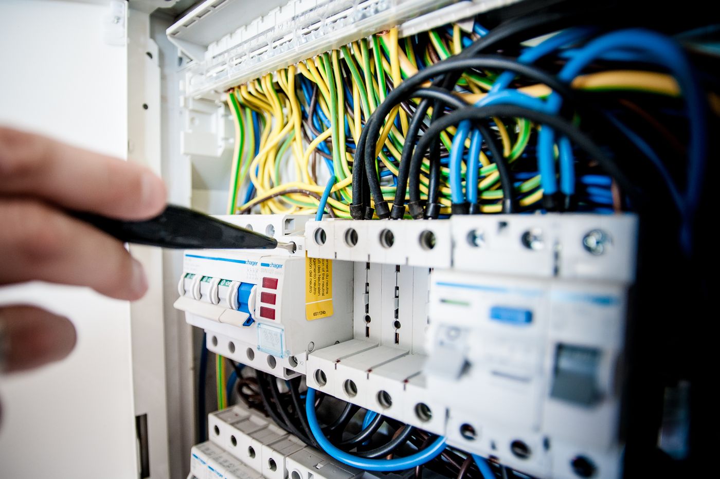 Electrician working on distribution panel wiring