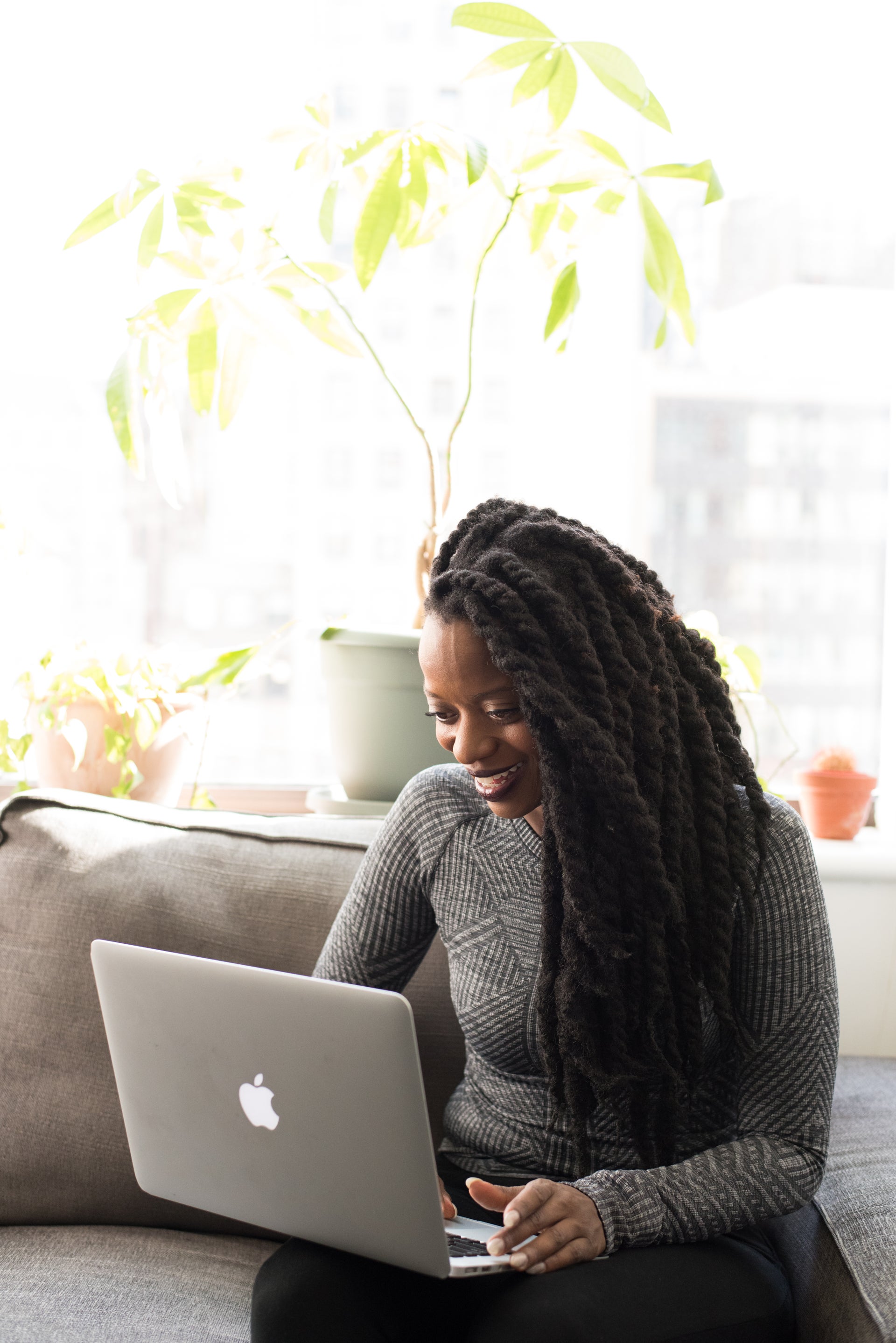 Professional working on a laptop in a bright, inclusive workplace